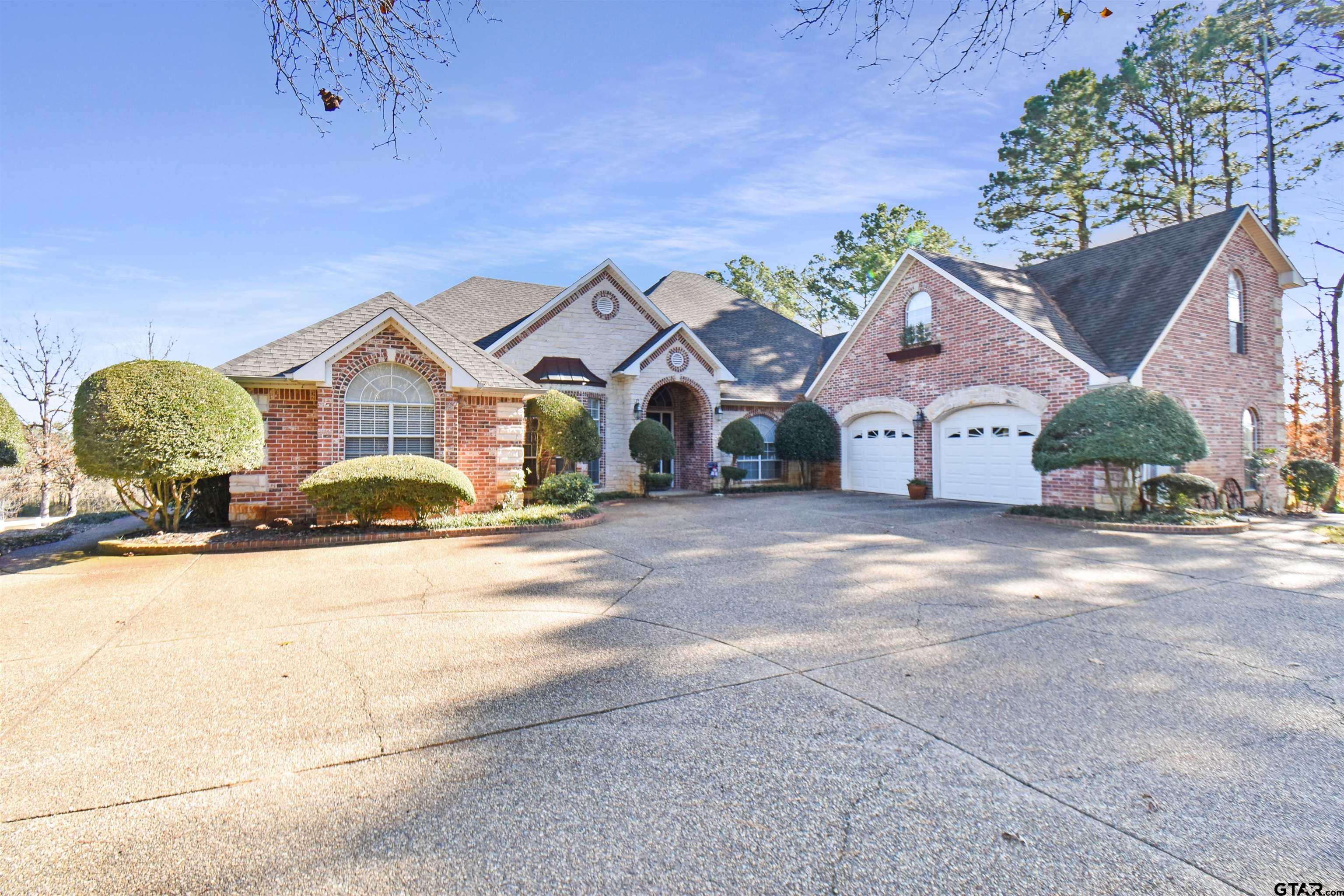 a view of a house with a yard and garage