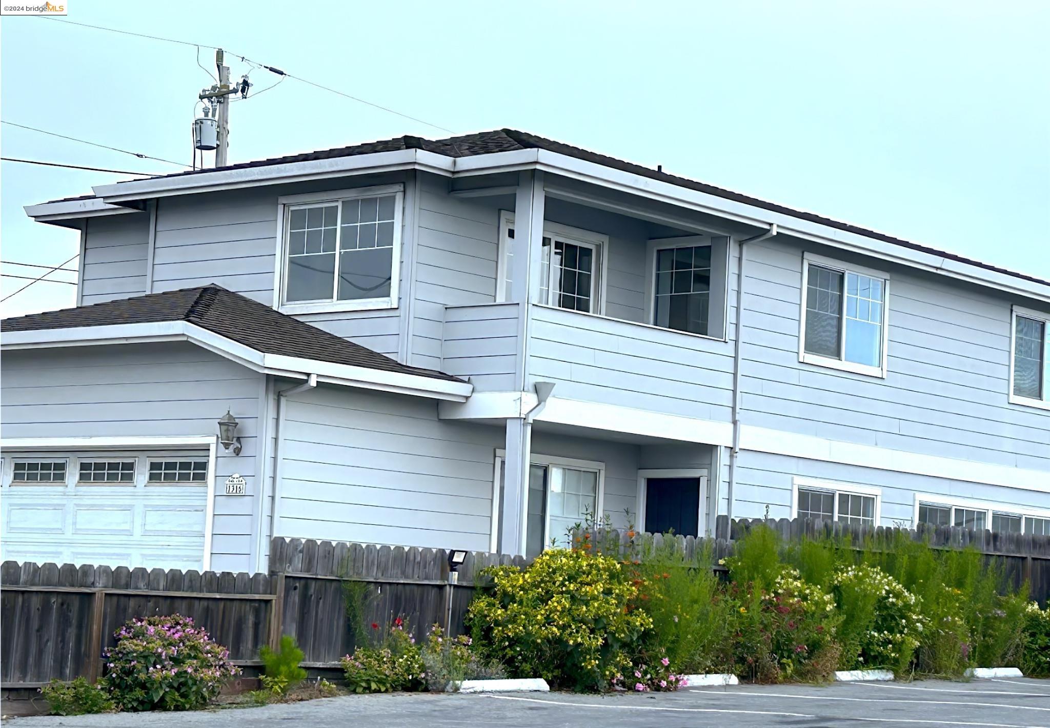 a front view of a house with plants