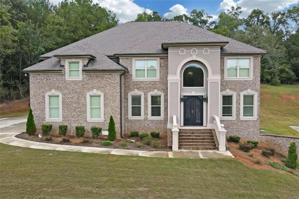 a front view of a house with a yard