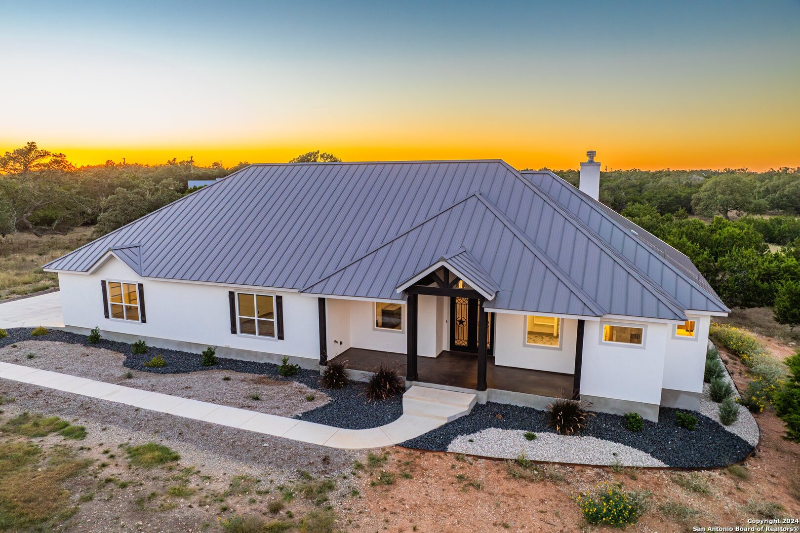 a front view of house with yard outdoor seating and barbeque oven