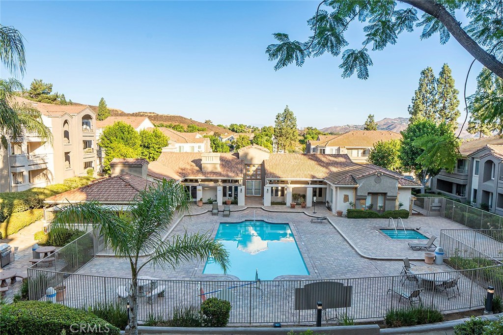 an aerial view of residential houses with outdoor space and swimming pool