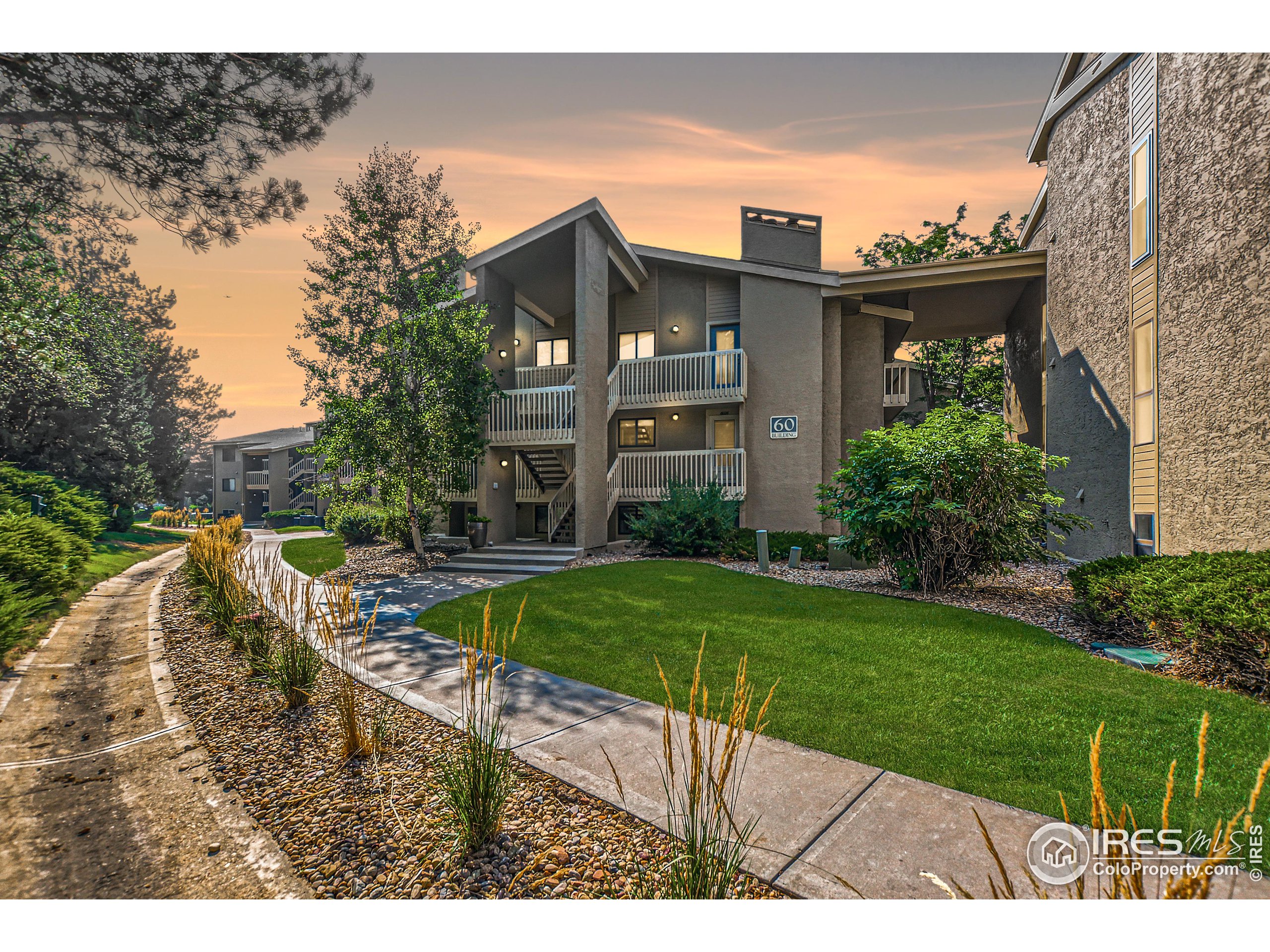 a view of a house with a yard from a lake view