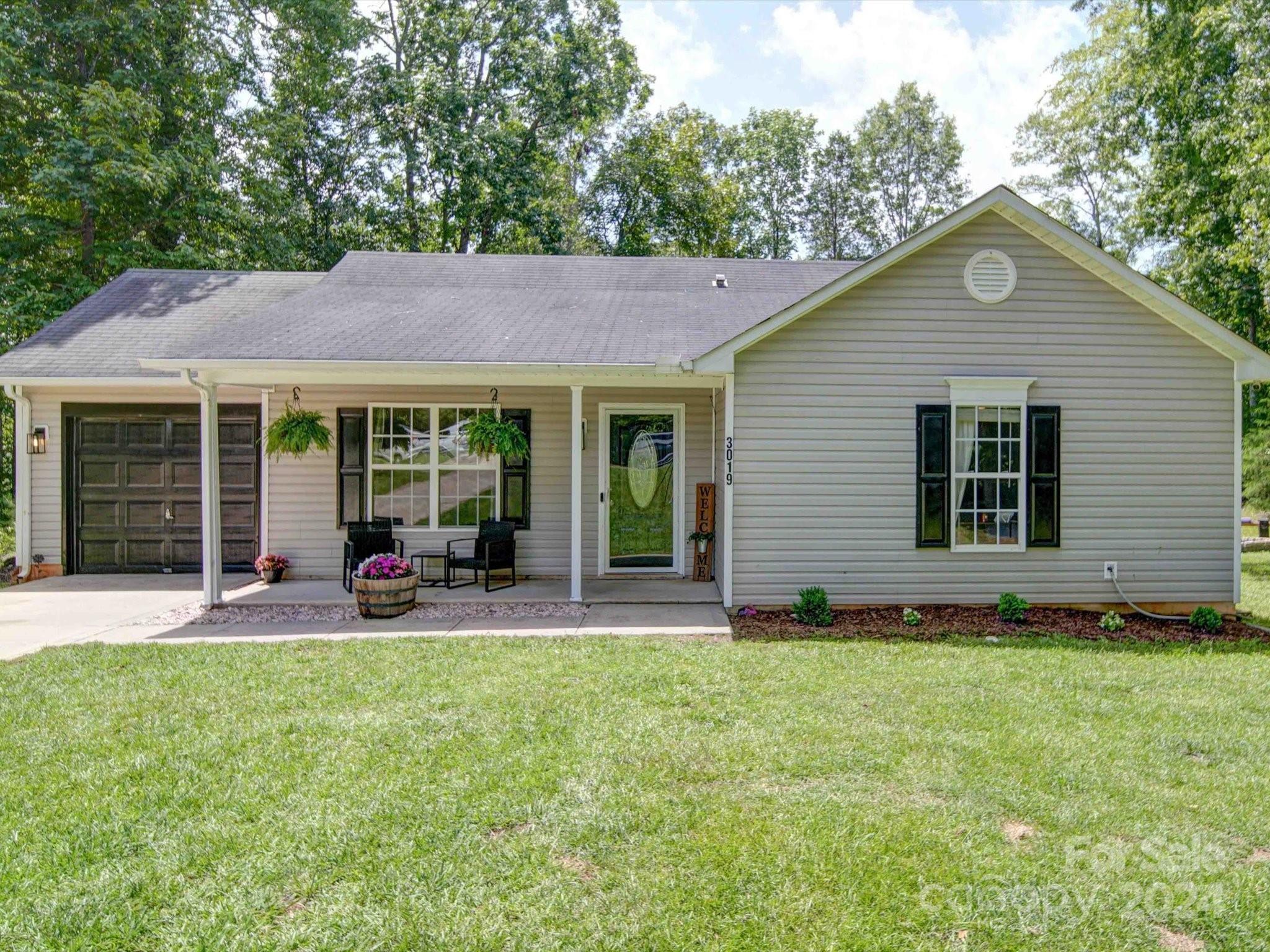 a front view of a house with yard and porch