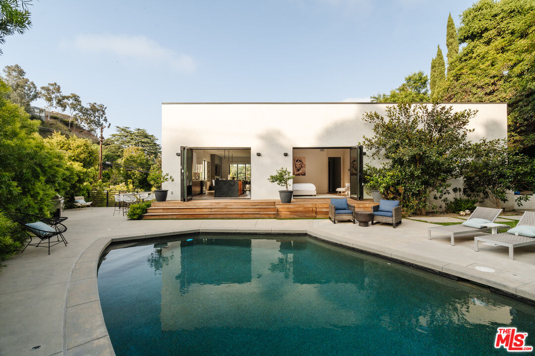 a view of a swimming pool with outdoor seating