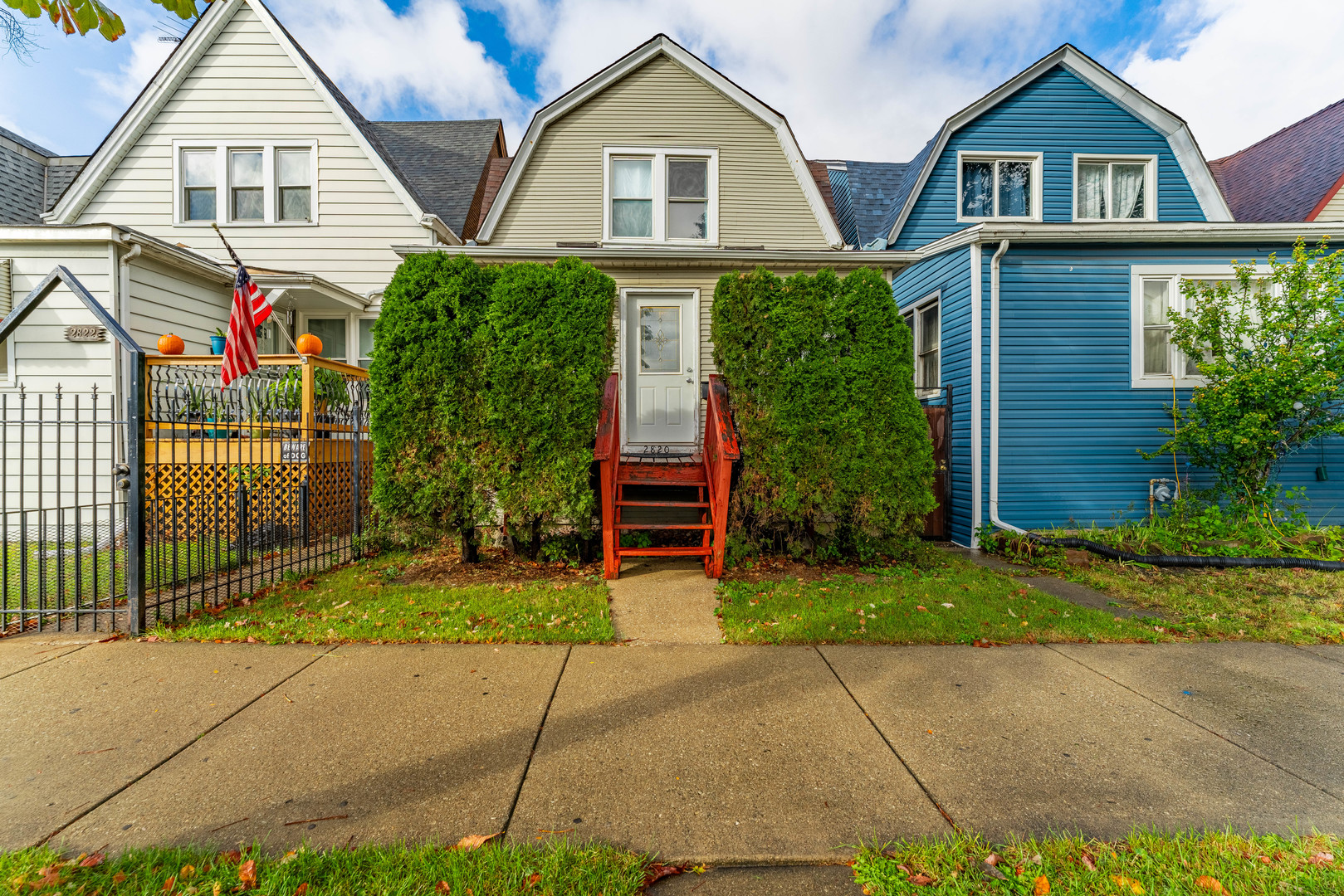 a front view of a house with a garden