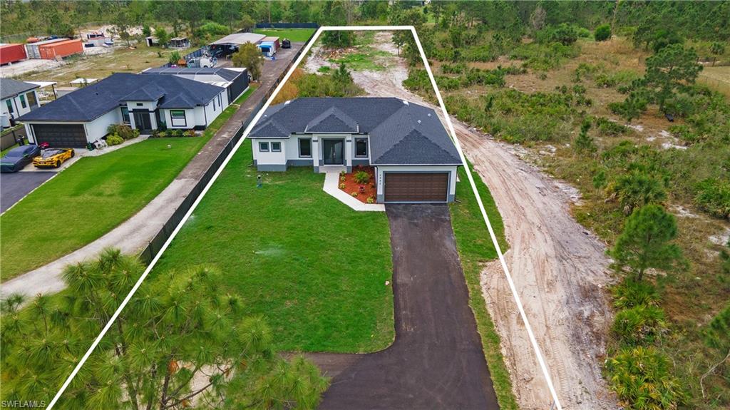 a aerial view of a house with a yard