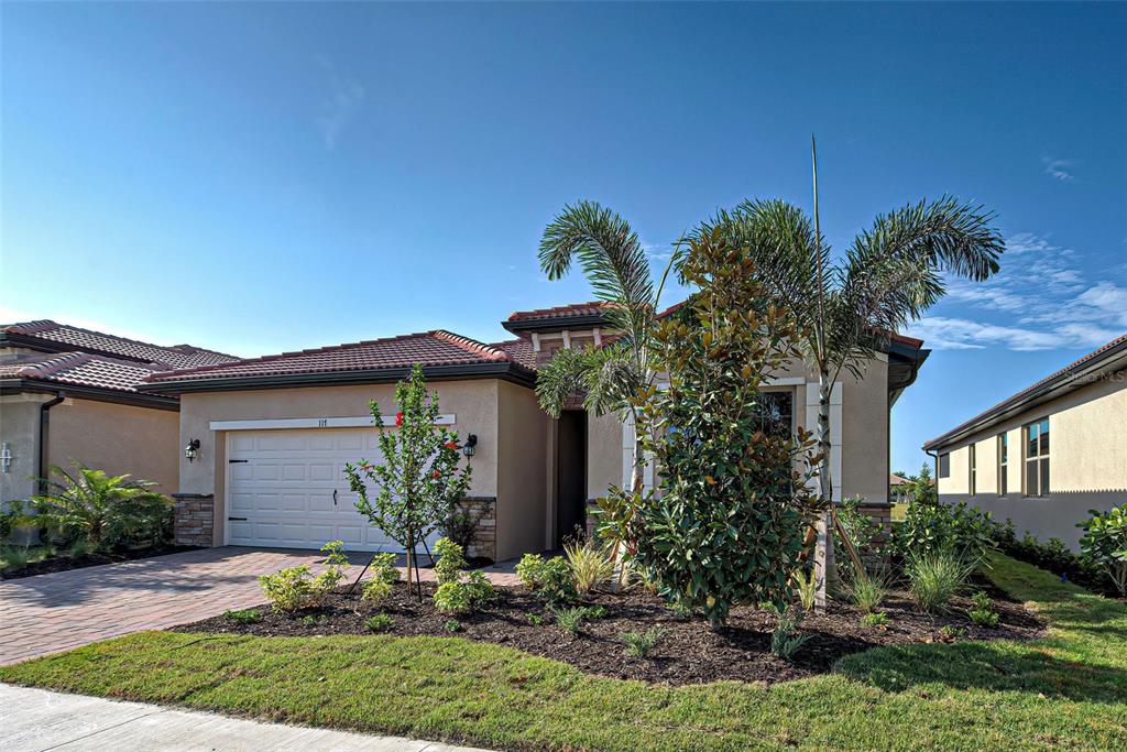 a view of a house with a yard and plants