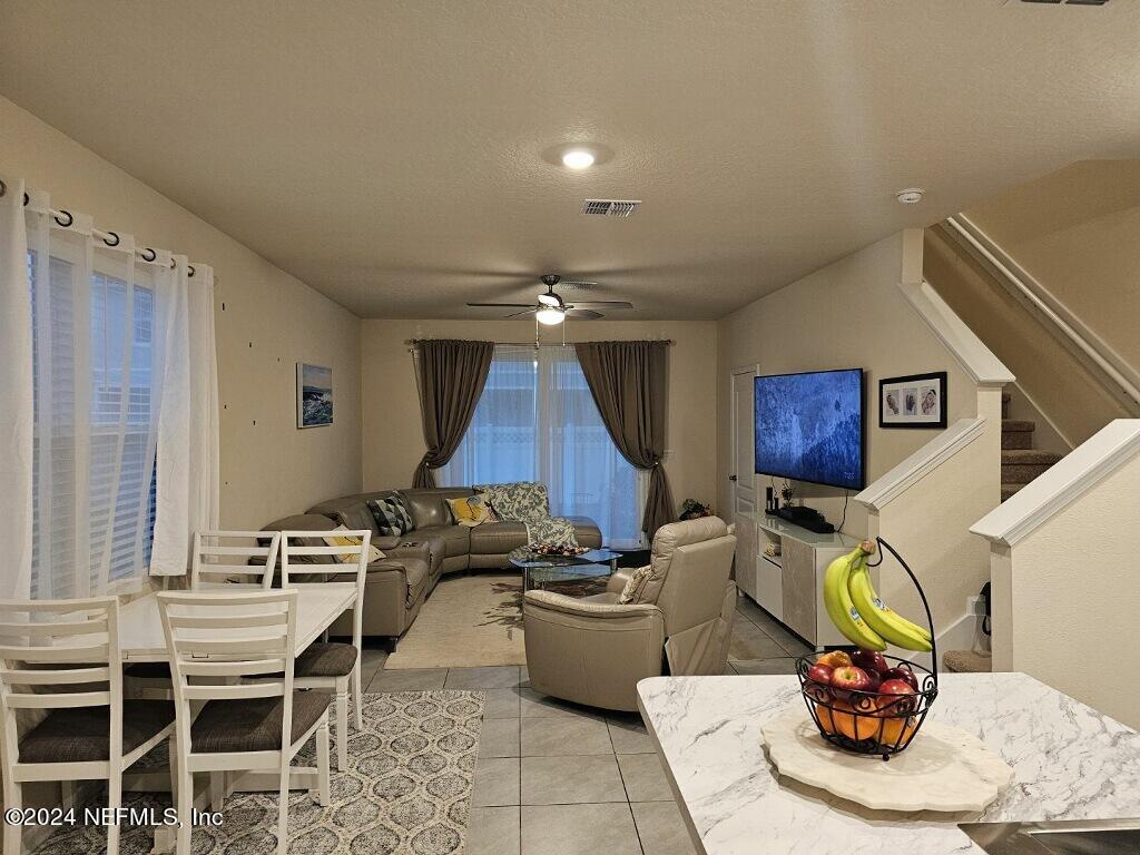 a living room with furniture a rug and a table