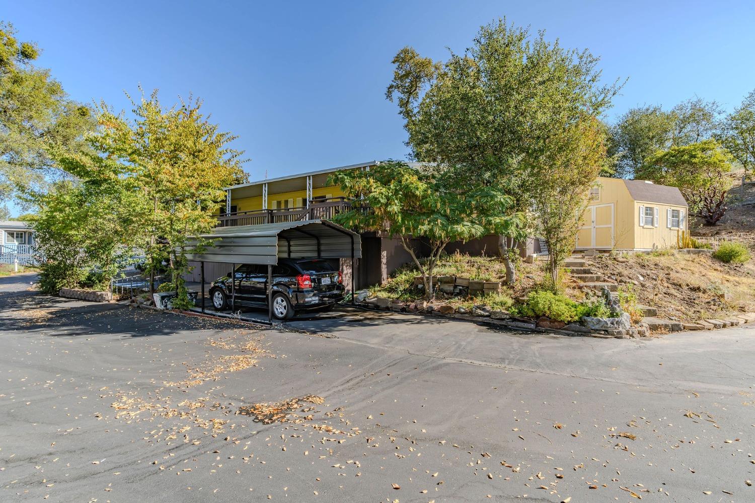 a view of a house with a yard and sitting area