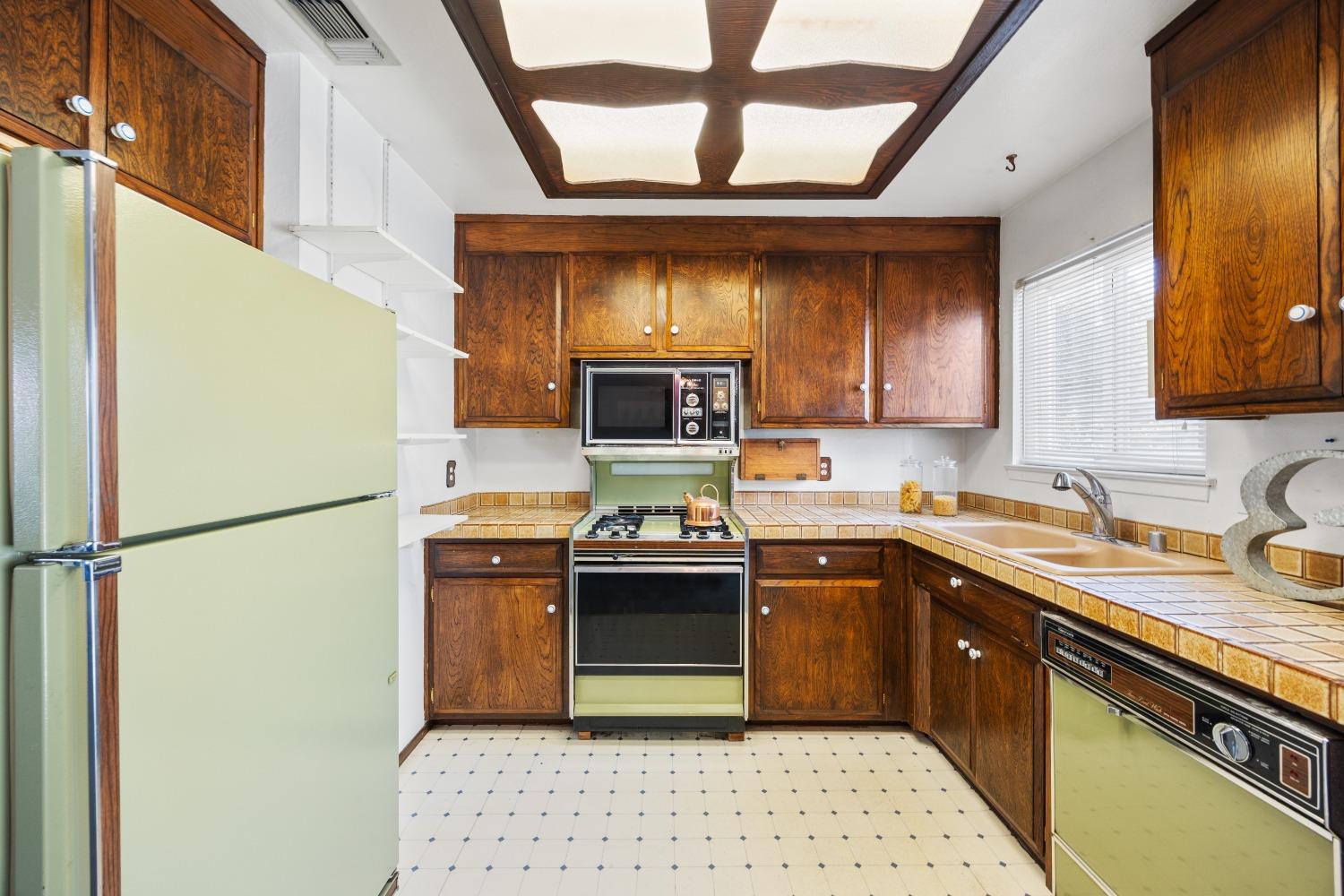 a kitchen with stainless steel appliances a refrigerator and a sink