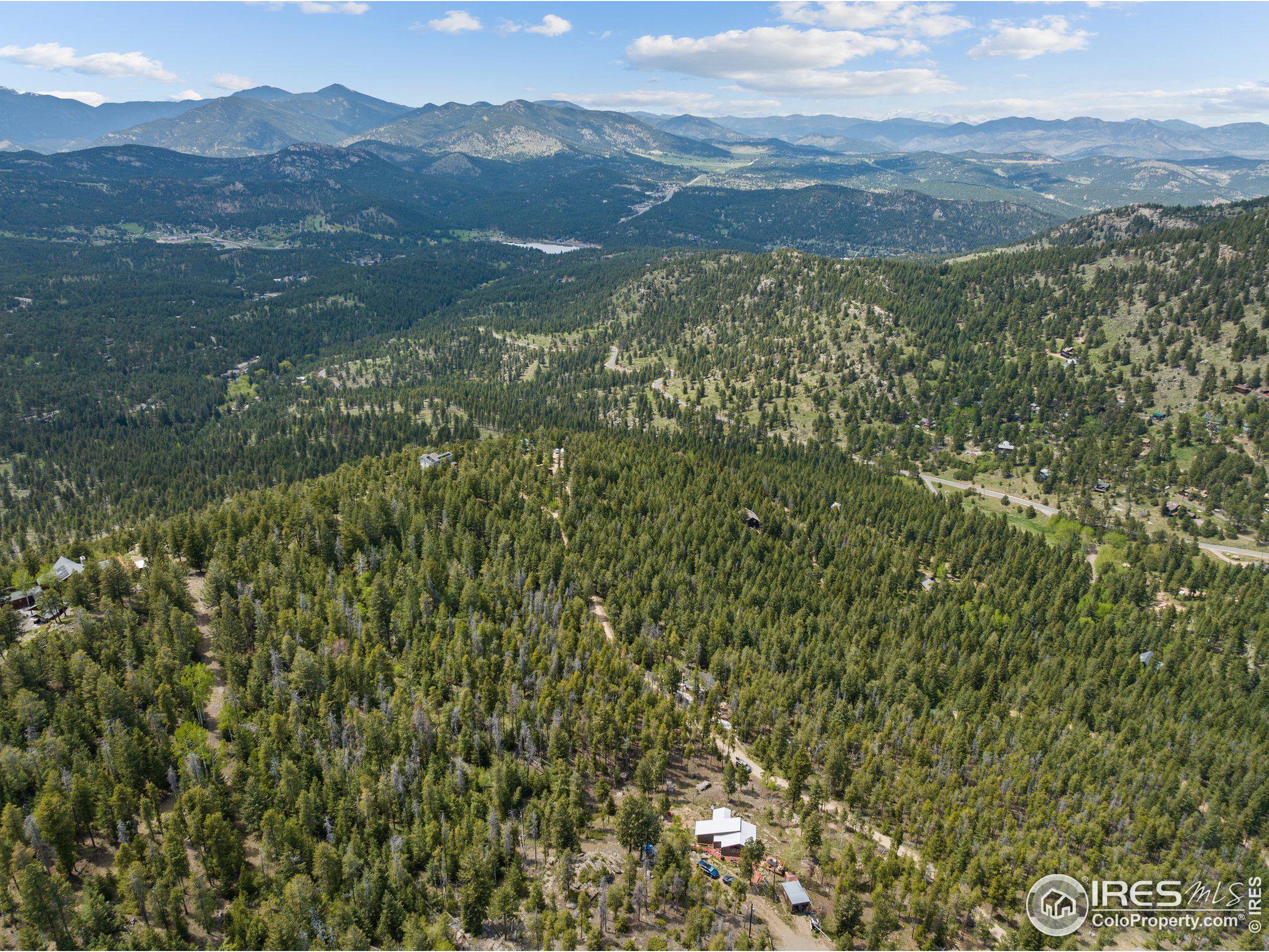 a view of a mountain range with lush green forest