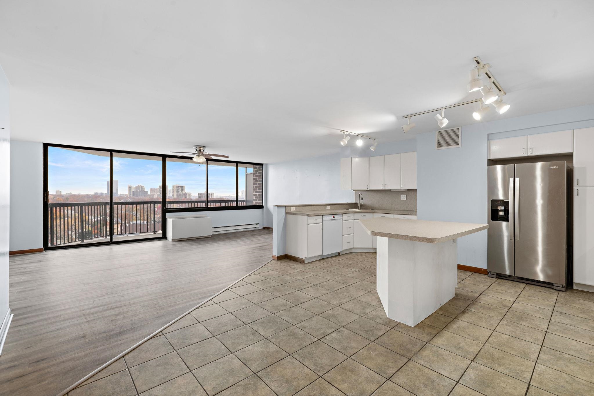 a view of a kitchen with furniture and a large window