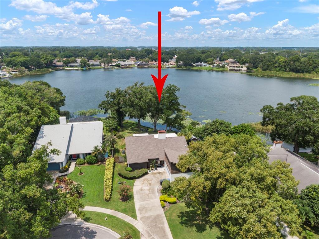 a view of a lake with a swimming pool and outdoor seating