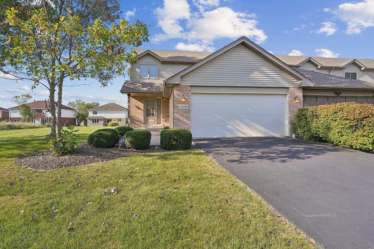 a front view of a house with a yard and garage