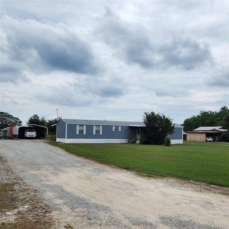 a view of a yard with a house in the background