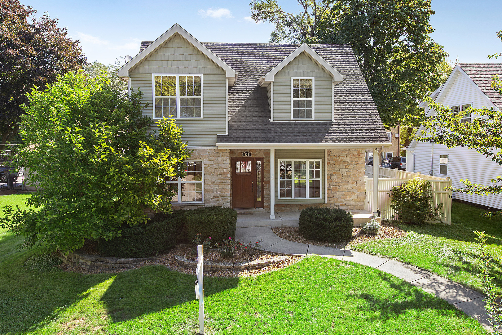 a front view of a house with a yard and porch