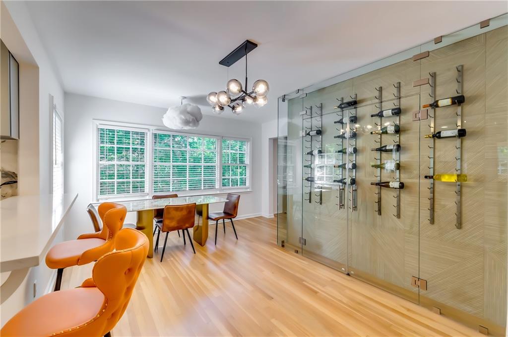 a dining room with furniture a chandelier and wooden floor