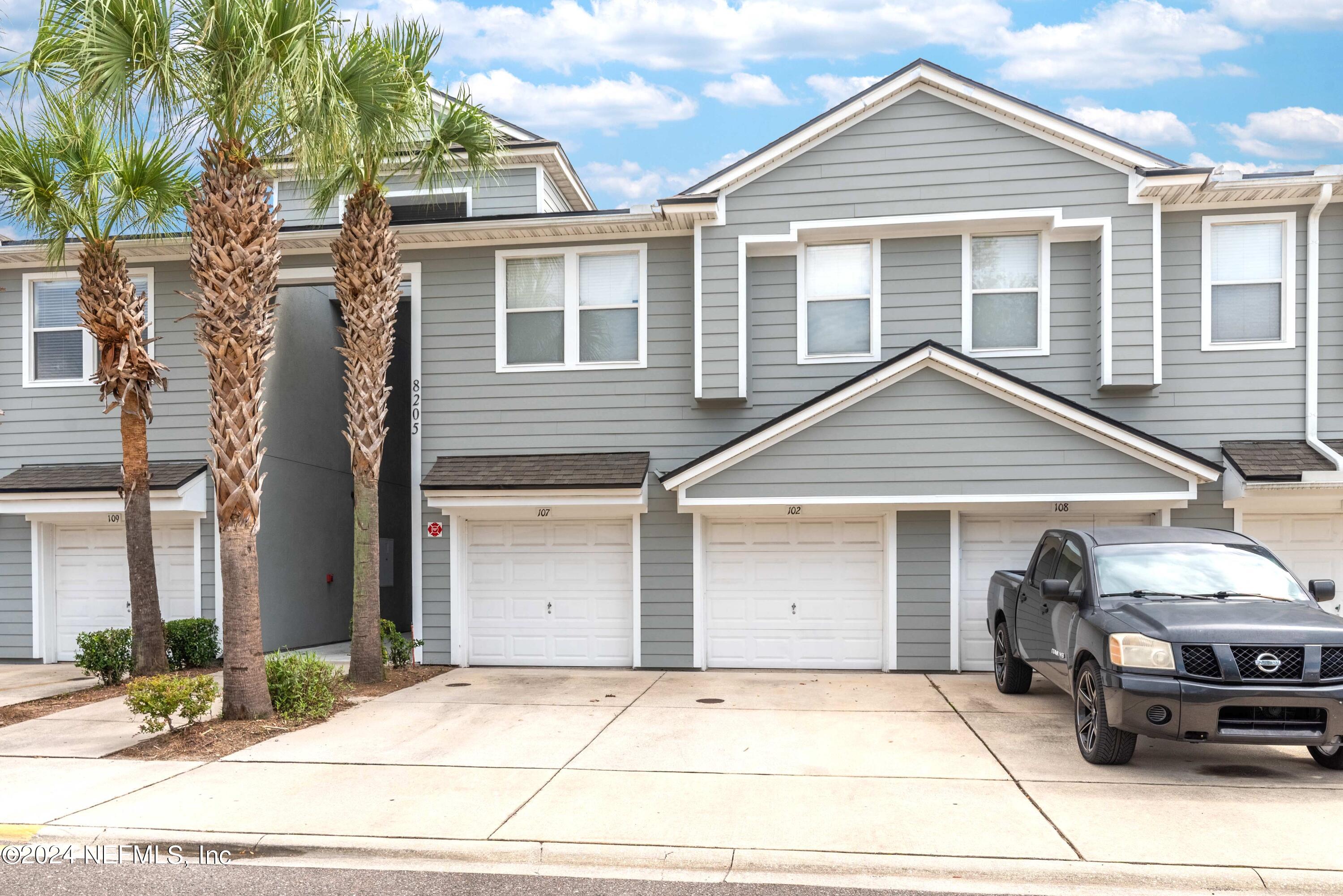 a front view of a house with garage