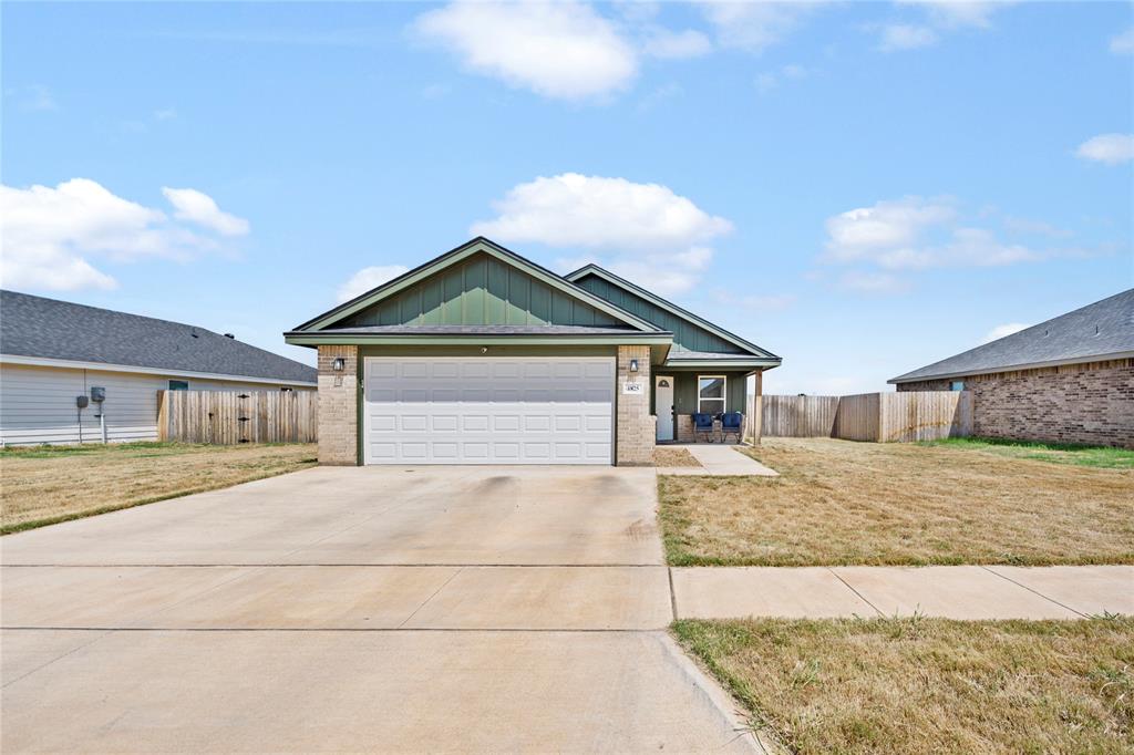 a view of a house with a yard and garage