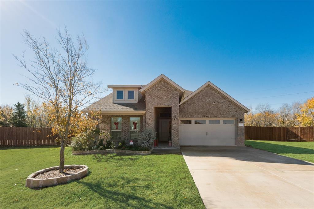 a front view of house with a garden and fire pit