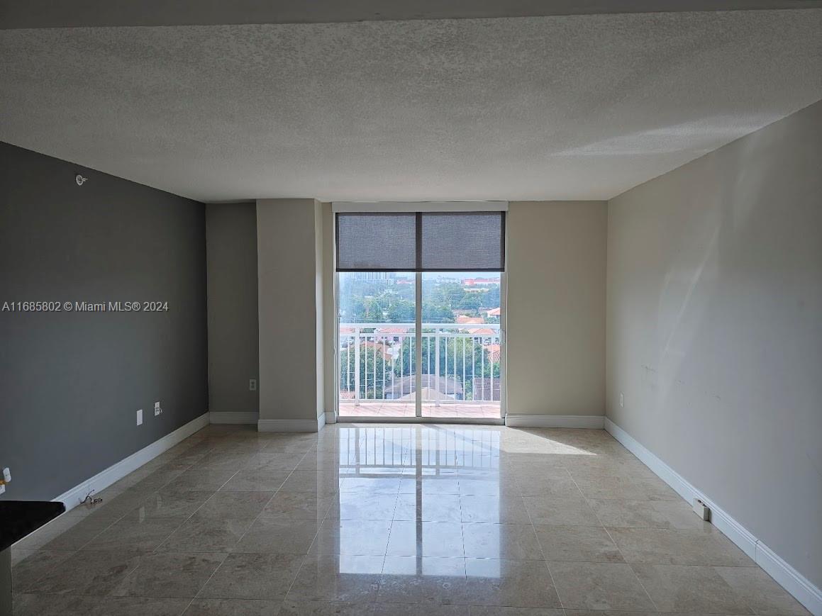 an empty room with sliding door and windows