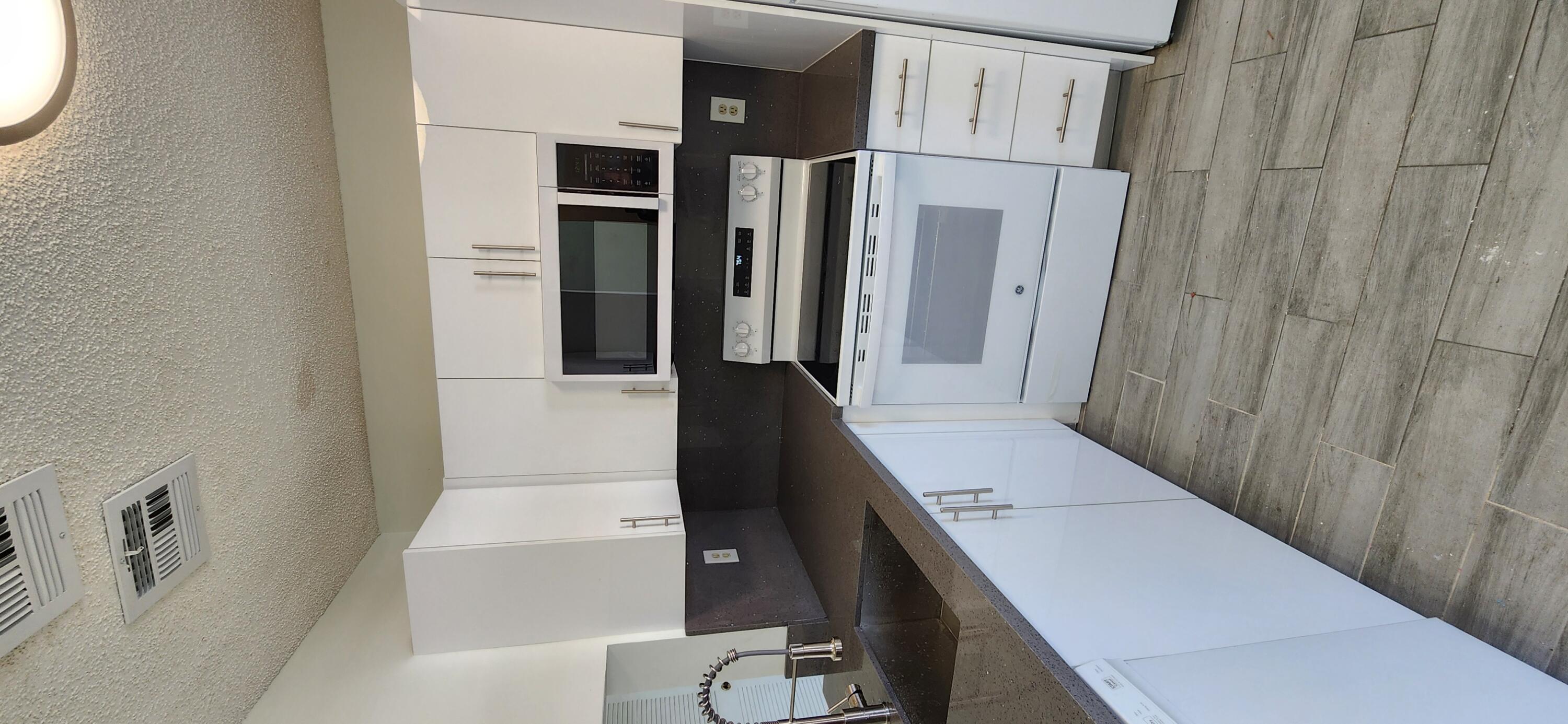 a kitchen with granite countertop a stove and a sink