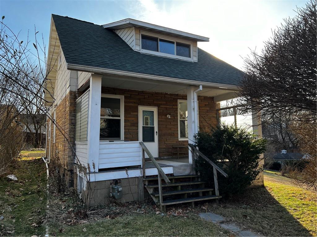 a view of house with backyard and outdoor seating