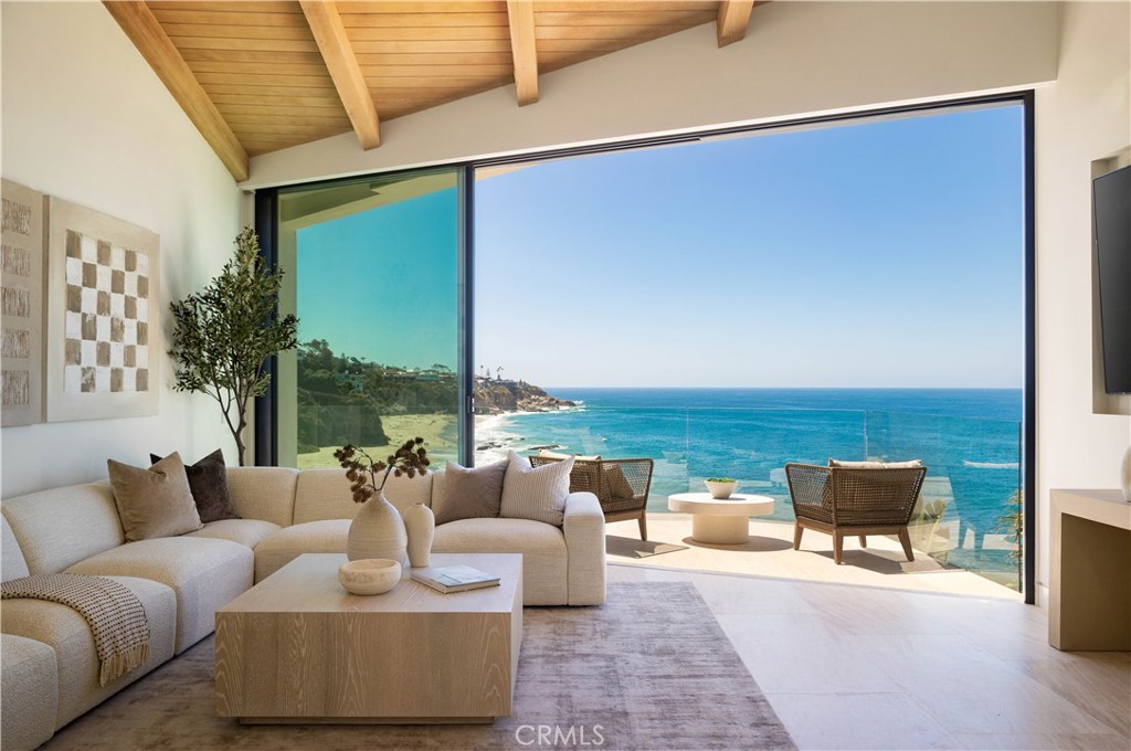 a living room with furniture and a floor to ceiling window