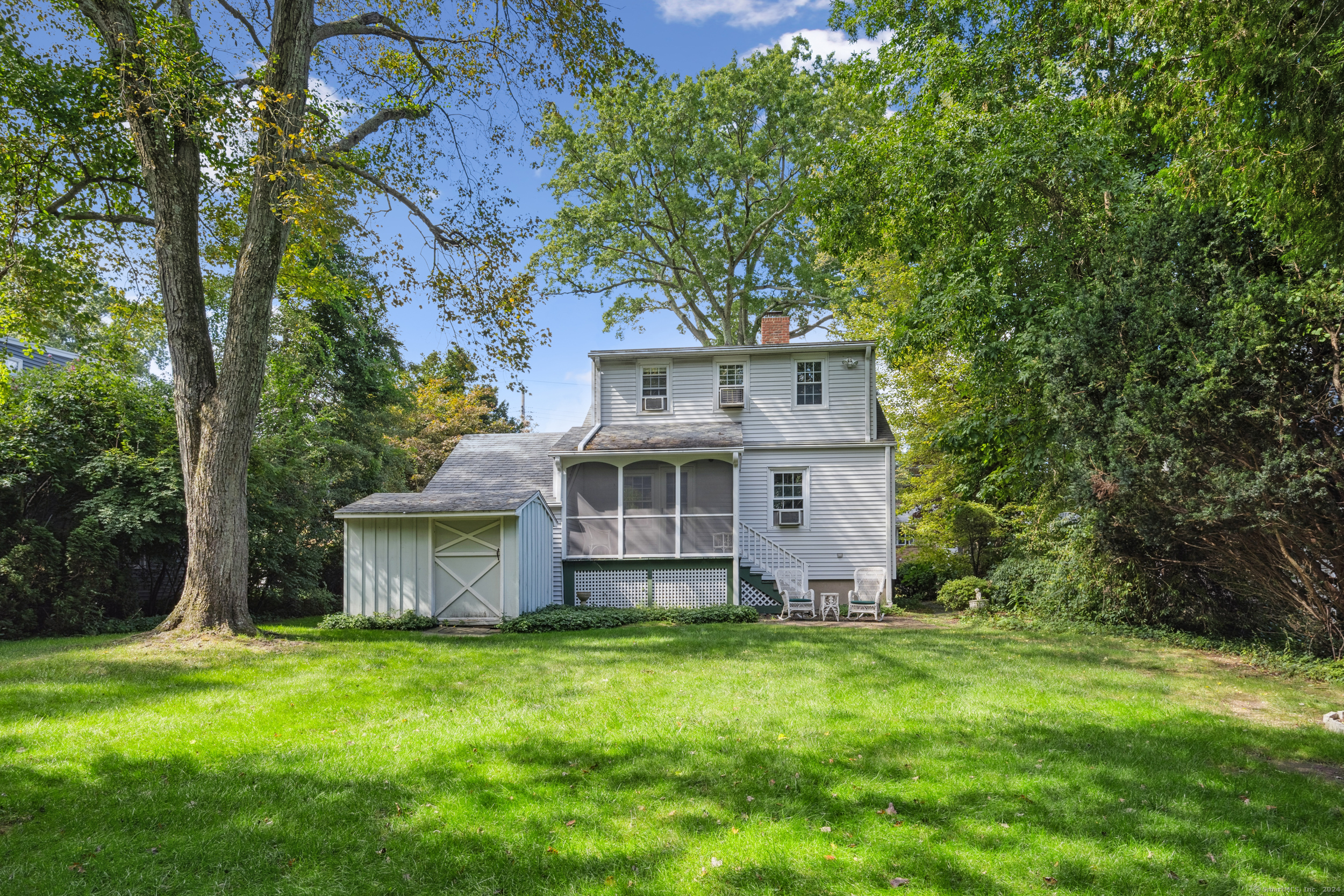 a front view of a house with a garden and yard