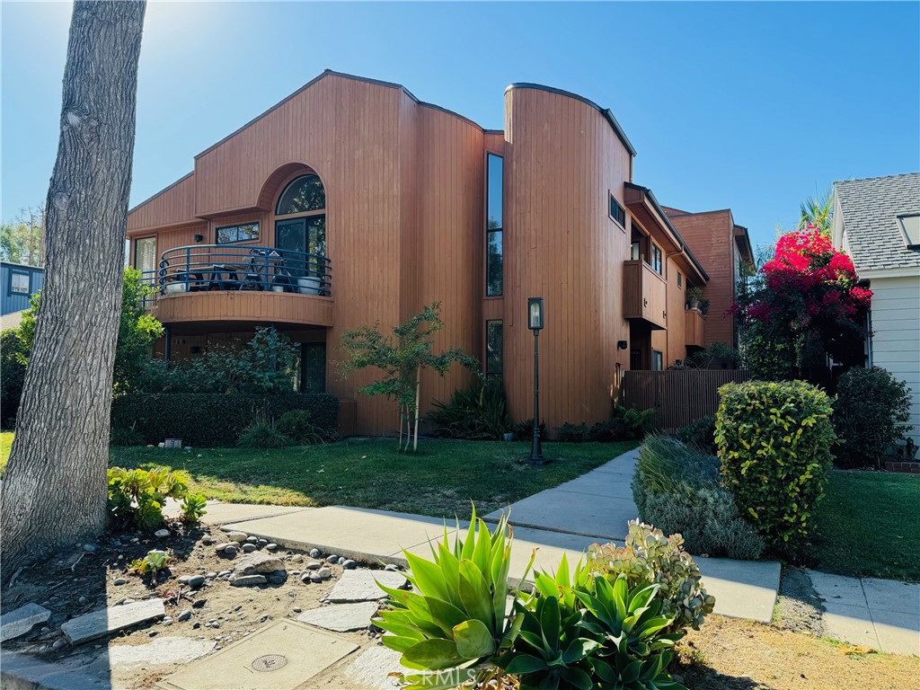 a front view of a house with a yard and outdoor seating