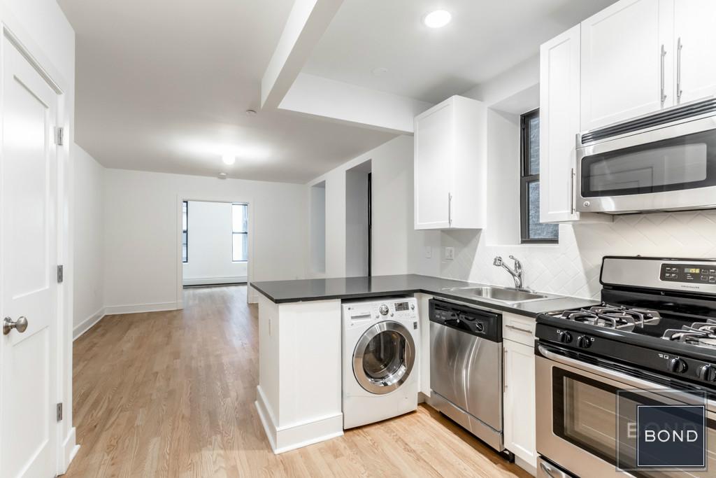 a kitchen with a stove top oven and cabinets