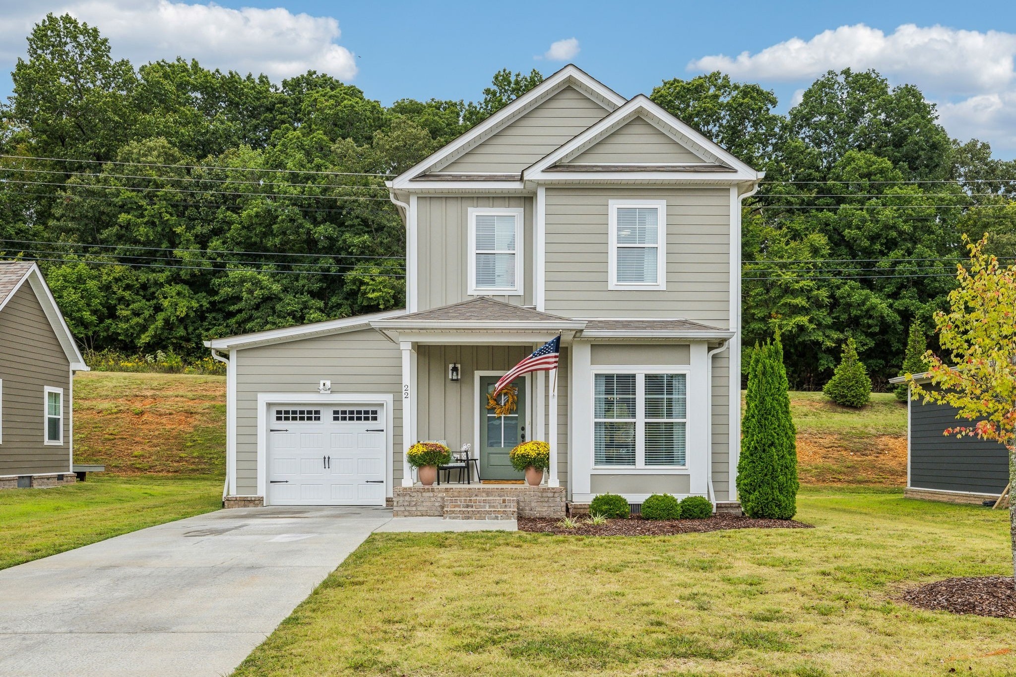 a front view of a house with a yard and garage