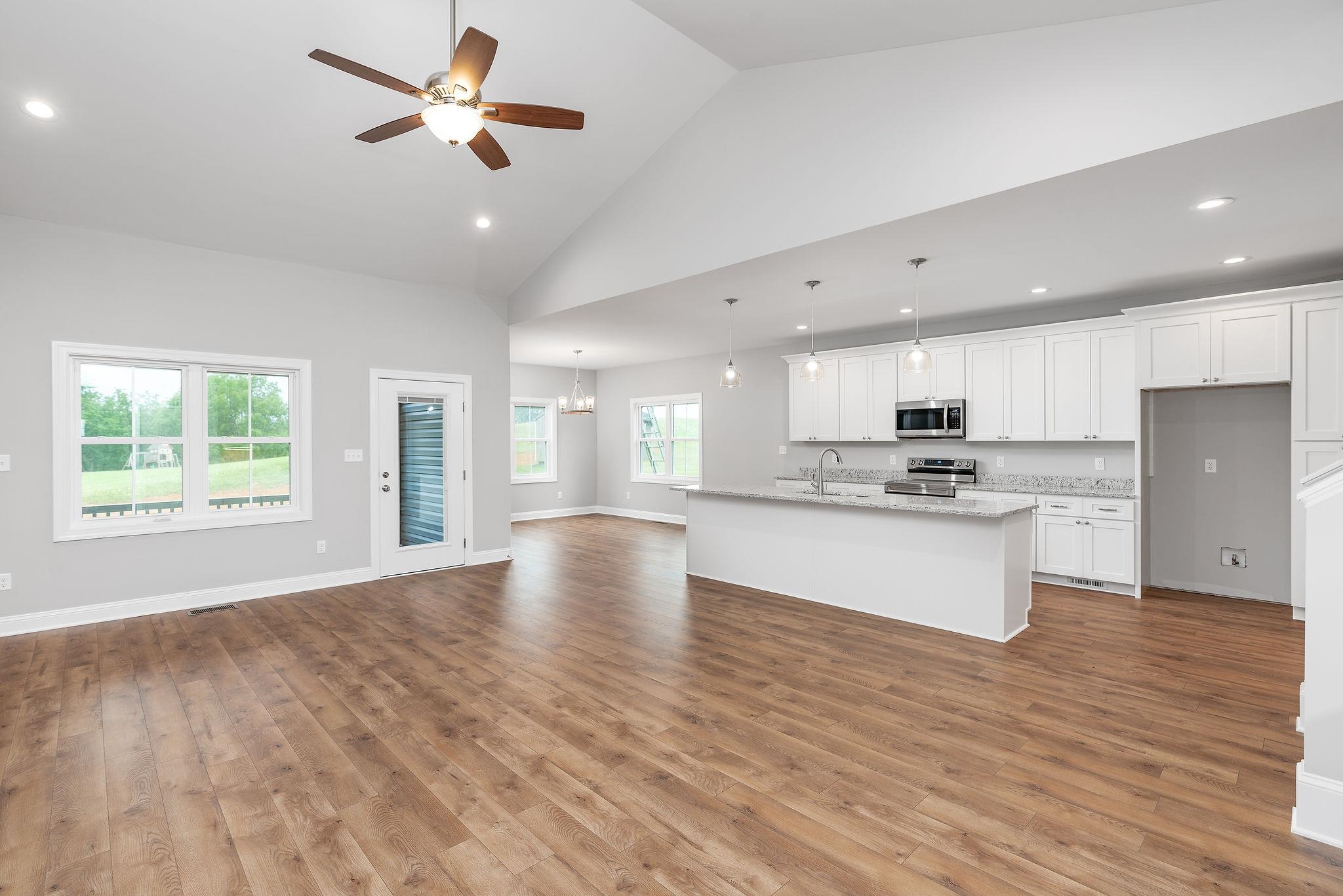 a view of kitchen with refrigerator and wooden floor