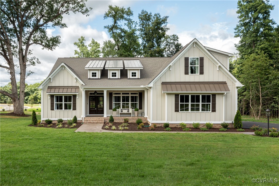 a front view of a house with a garden and trees