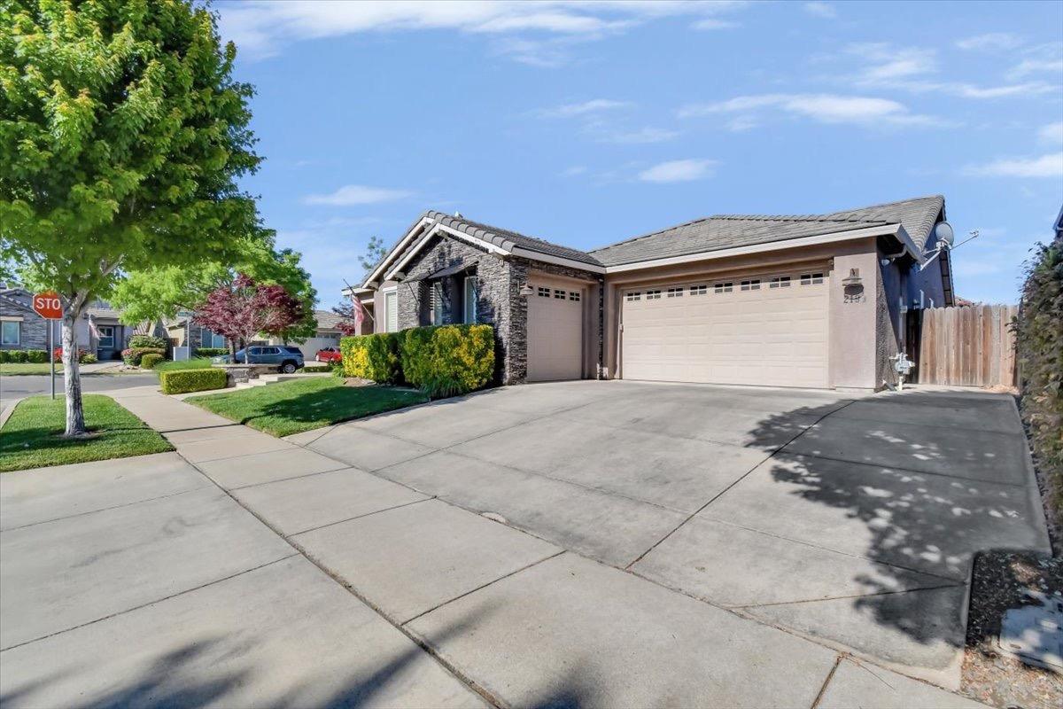 a front view of a house with a yard and garage