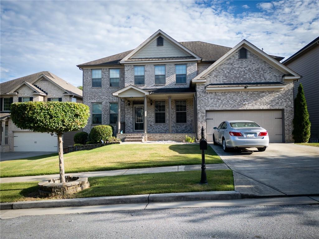 a front view of a house with garden