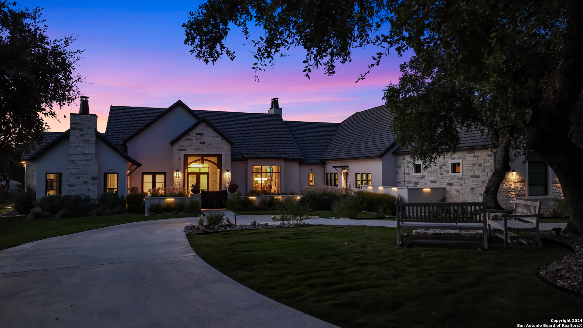 a front view of a house with a garden