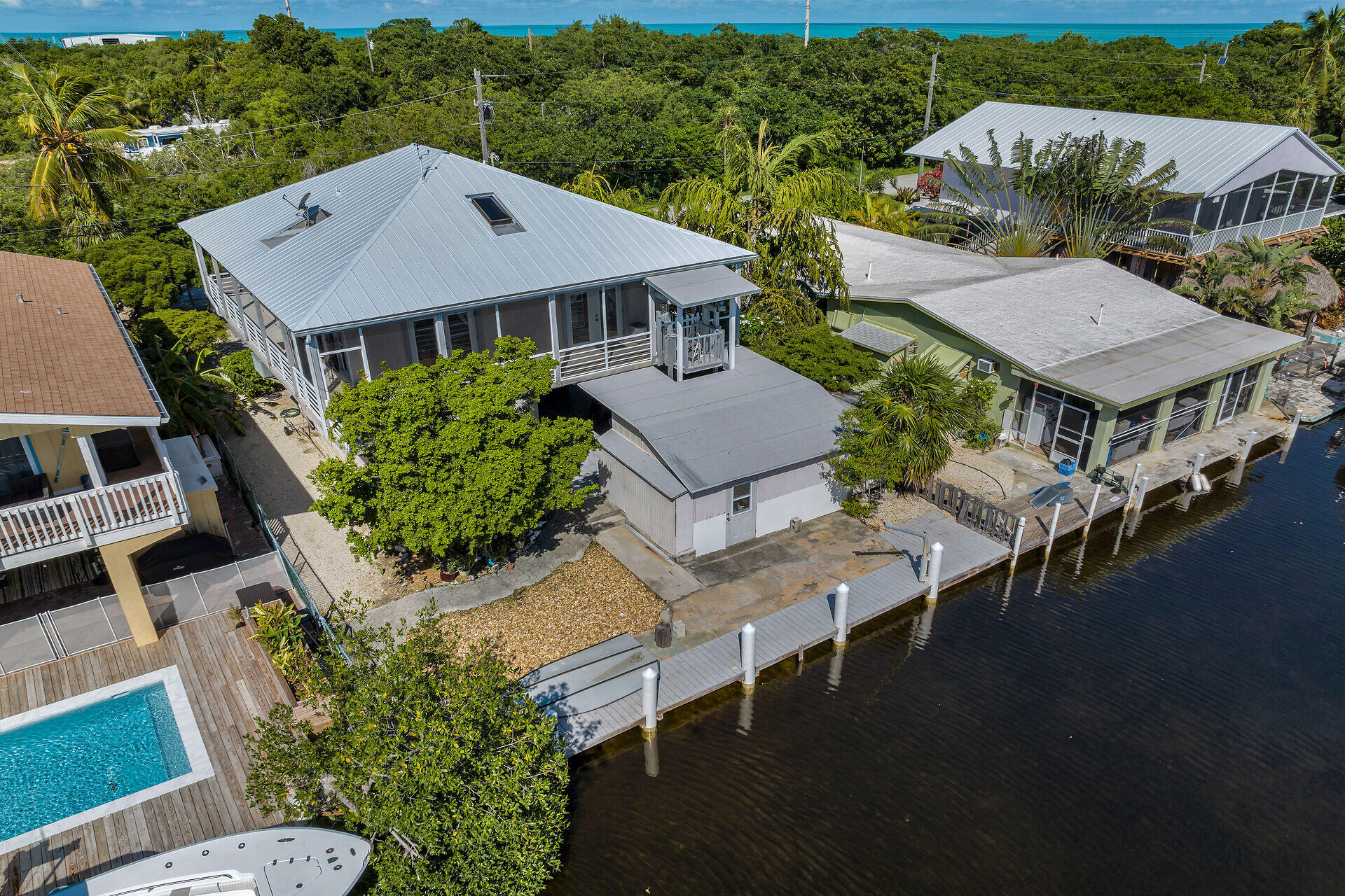 an aerial view of a house with swimming pool and outdoor seating