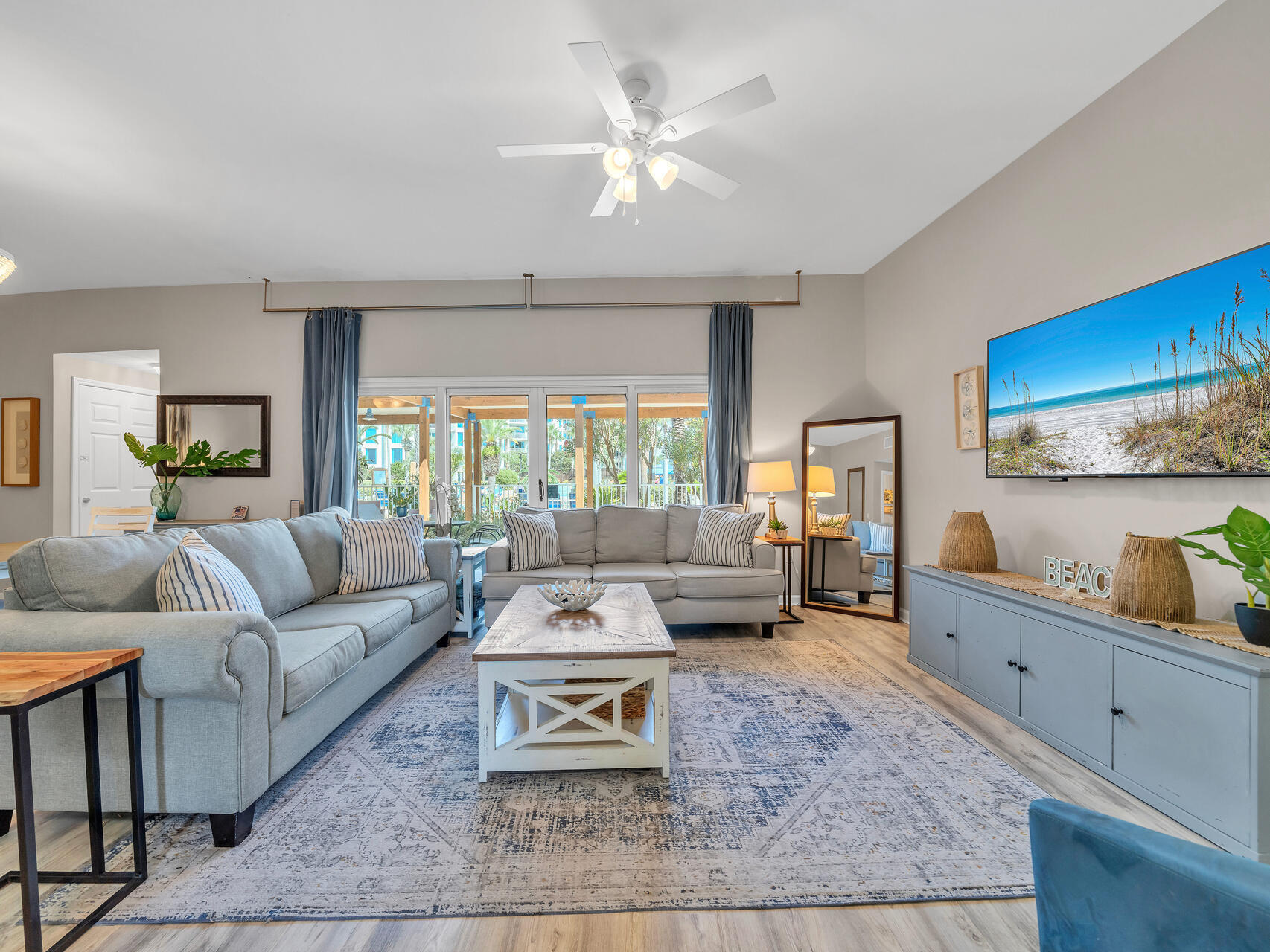 a living room with furniture and wooden floor