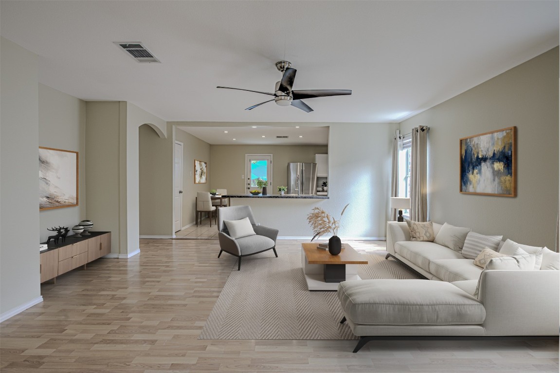 a living room with furniture and wooden floor