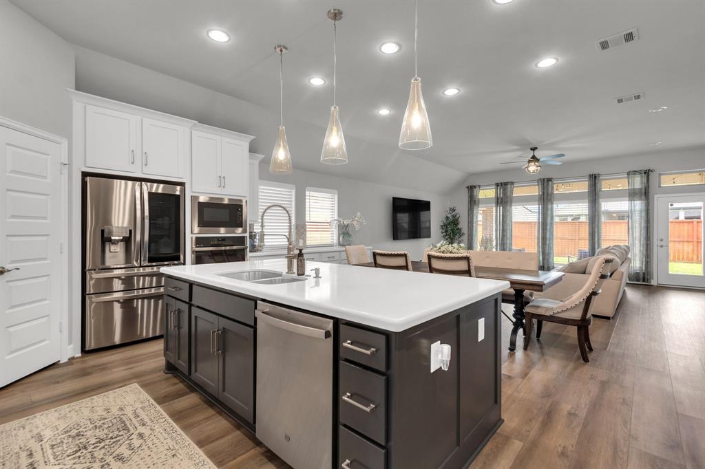 a large kitchen with kitchen island a sink stove and refrigerator