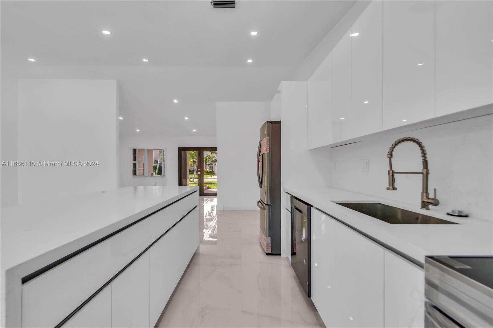 a kitchen with a sink stainless steel appliances and cabinets