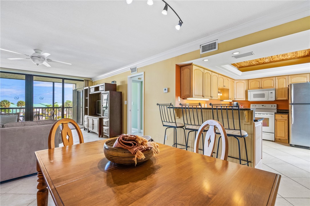 a dining room with furniture and a floor to ceiling window