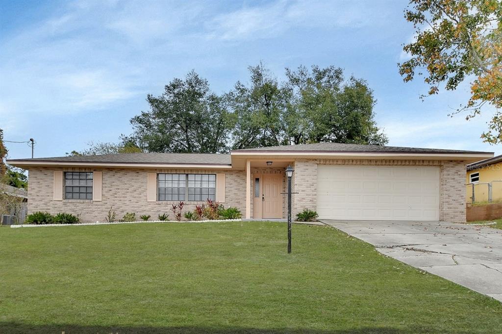 a front view of house with yard and green space