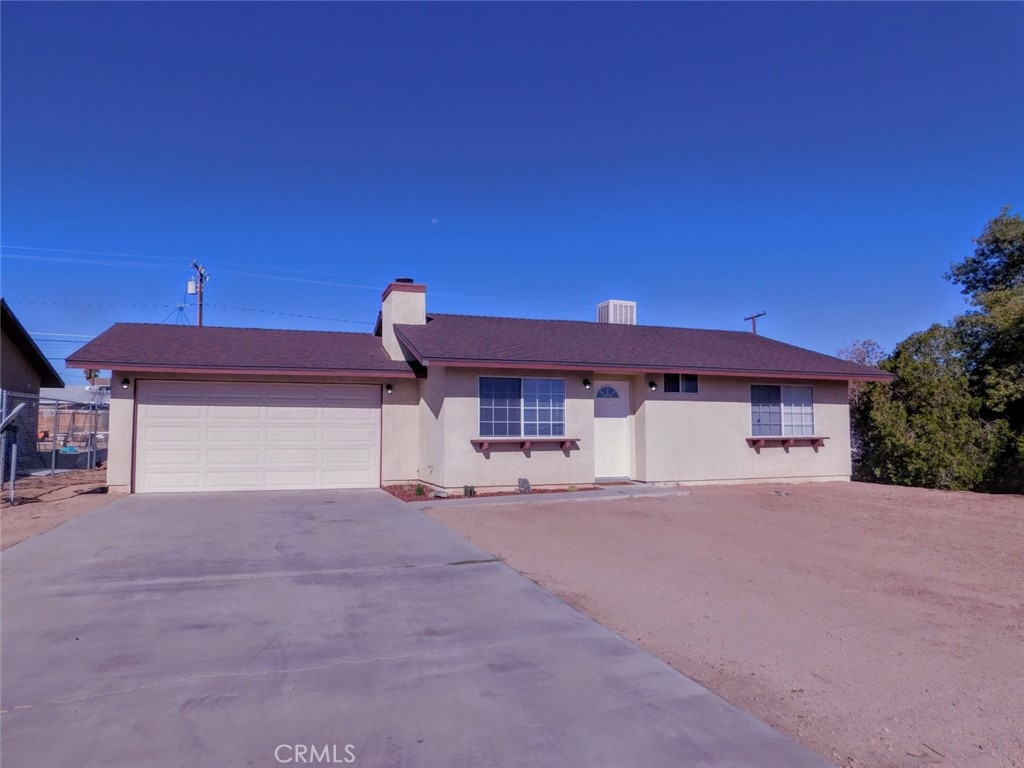 a view of a house with a yard and garage