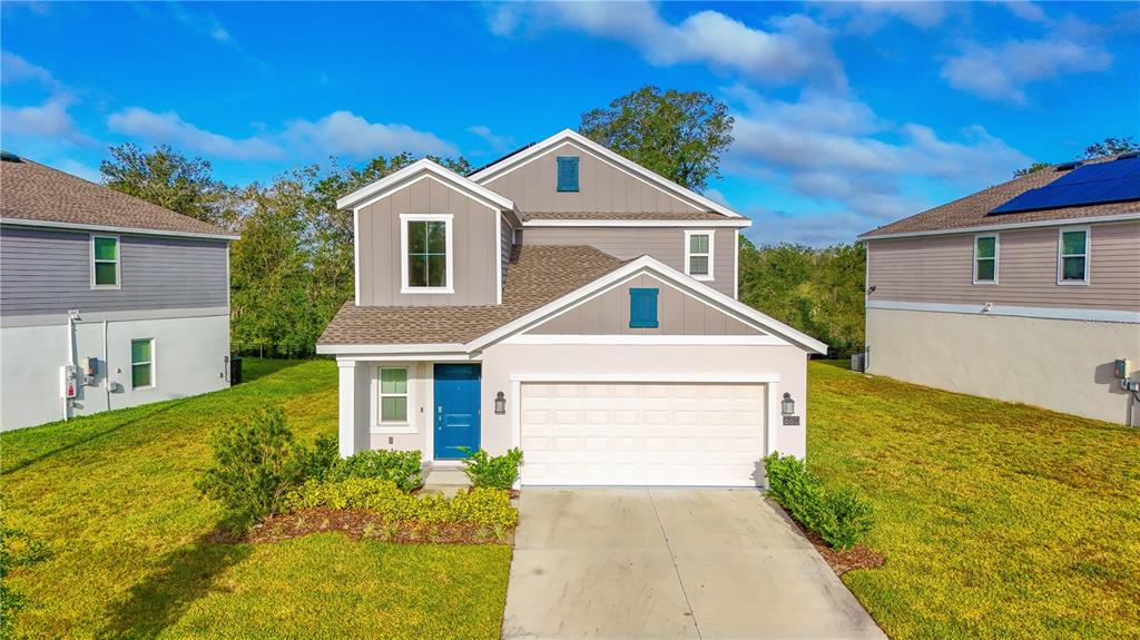 a front view of a house with a yard and garage