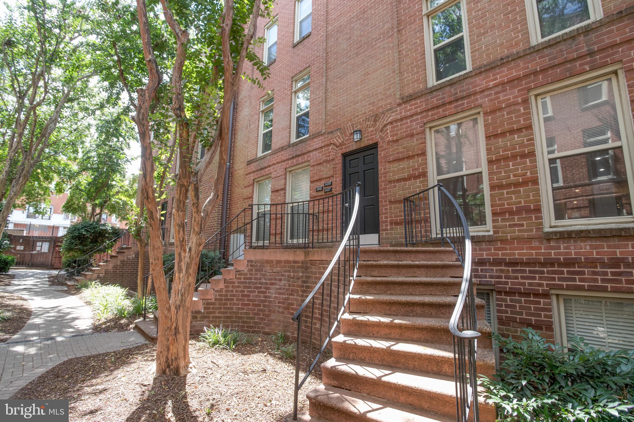 a view of a brick house with many windows