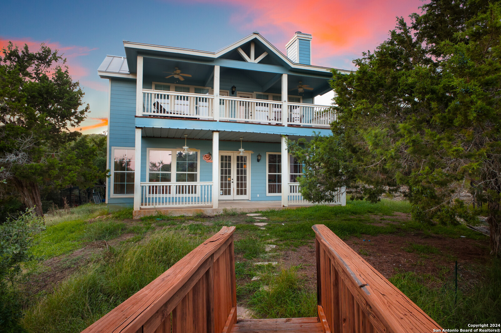 a front view of house with yard and green space