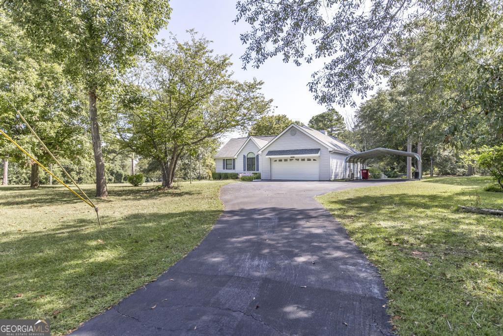 a front view of house with yard and green space