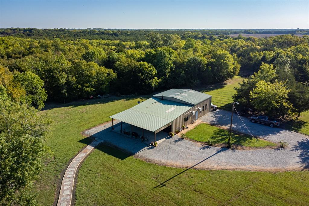 an aerial view of a house with a yard